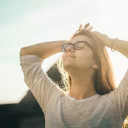 A woman breathing in outside.