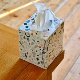 A box of tissues sitting on a countertop.
