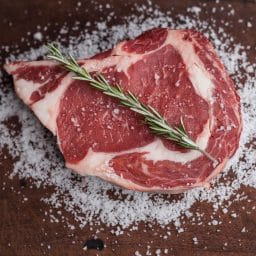 Uncooked steak with garnish..