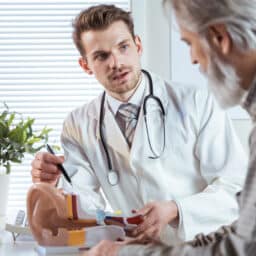 Audiologist talking with a patient about hearing loss.