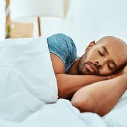 Man sleeping in bed.